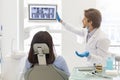 Dentist doctor showing his patient x-ray results Royalty Free Stock Photo