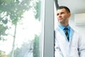 Dentist Doctor Stands Near Window and Thinks about Clinic Future