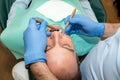 Dentist doing a dental treatment on a patient Royalty Free Stock Photo