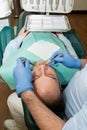 Dentist doing a dental treatment on a patient Royalty Free Stock Photo
