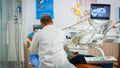 Dentist drilling woman tooth in dental clinic