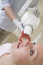 Dentist in exam room with woman in chair