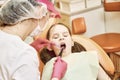 Pediatric dentistry. Dentist treats teeth of little girl