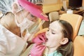 Pediatric dentistry. Dentist treats teeth of little girl