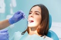 The dentist examines the teeth of a young girl at his reception