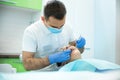 Dentist examines young woman`s mouth in dental office