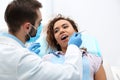 Dentist examining African-American woman`s teeth Royalty Free Stock Photo