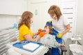 Dentist examining boy`s teeth in clinic. A small patient in the dental chair smiles.