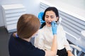 Dentist examining female patient`s teeth in modern clinic. Royalty Free Stock Photo