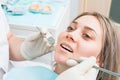 Dentist examining a patient`s teeth, beautiful woman closeup portrait during dental examination. Royalty Free Stock Photo