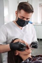 Dentist examining patient teeth with a mouth mirror and dental excavator. Close-up view on the woman`s face Royalty Free Stock Photo