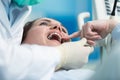 Dentist examining Patient teeth with a Mouth Mirror.