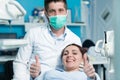 Dentist examining Patient teeth with a Mouth Mirror. Royalty Free Stock Photo