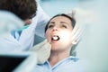 Dentist examining Patient teeth with a Mouth Mirror. Royalty Free Stock Photo