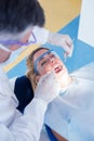 Dentist examining a patients teeth in the dentists chair Royalty Free Stock Photo