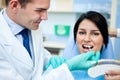 Dentist examining a whiteness of teeth of a patient Royalty Free Stock Photo