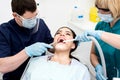 Dentist examining a woman teeth