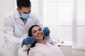 Dentist examining young woman`s teeth in modern clinic Royalty Free Stock Photo