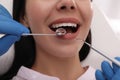 Dentist examining young woman`s teeth, closeup view Royalty Free Stock Photo