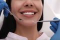 Dentist examining young woman`s teeth, closeup view Royalty Free Stock Photo