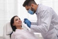 Dentist examining young woman`s teeth in modern clinic Royalty Free Stock Photo