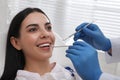 Dentist examining young woman`s teeth in modern clinic Royalty Free Stock Photo