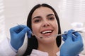 Dentist examining young woman`s teeth in modern clinic Royalty Free Stock Photo