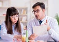 Dentist explaining student tooth structure Royalty Free Stock Photo