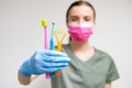Dentist in face mask holding toothbrushes in her hand Royalty Free Stock Photo