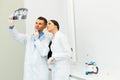 Dentist and female assistant are discussing dental X Ray image Royalty Free Stock Photo