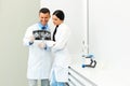 Dentist and female assistant are discussing dental X Ray image Royalty Free Stock Photo