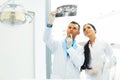 Dentist and female assistant are discussing dental X Ray image Royalty Free Stock Photo