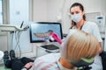 Dentist female doctor in uniform showing scan of intraoral 3D dental scanner Machine to patient. Dental clinic patient visit Royalty Free Stock Photo