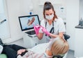 Dentist female doctor in uniform using intraoral 3D dental scanner Machine for clear aligners production. Dental clinic patient Royalty Free Stock Photo