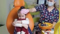 A dentist girl calms a little girl before starting treatment.