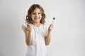 Dentist girl holding dental tools on white background