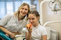 Dentist gives apple for smiling teenage girl