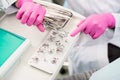 Dentist with gloved hands is working with dental equipment in dental clinic