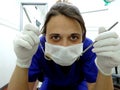 Dentist with gloves, mask, mirror and explorer