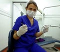 Dentist with gloves, mask, mirror and explorer