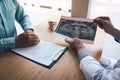 Dentist hand holding pen pointing x-ray picture and talking to the patient about medication and surgery treatment