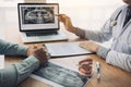 Dentist hand pointing x-ray picture in laptop computer and talking to the patient about medication and surgery treatment