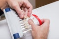 Dentist hands with color guide and plaster model Royalty Free Stock Photo