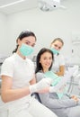 A dentist and his assistant showing a patient x-rays