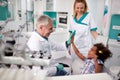Dentist with his patient giving five in dental ambulance Royalty Free Stock Photo