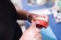 Dentist holding an artificial lower jaw. Dental Prosthesis. Zirconium porcelain tooth plate. Prosthetics work