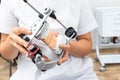 Dentist holding dental articulator with dental gypsum prosthesis model in dental laboratory