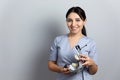 Dentist holding dental articulator with dental gypsum prosthesis model in dental laboratory