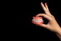 The dentist is holding dentures in his hands. Dental prosthesis in the hands of the doctor close-up.