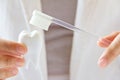 Dentist holding molar with brush